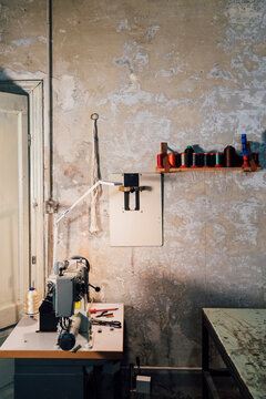 Sewing machine in front of wall workshop