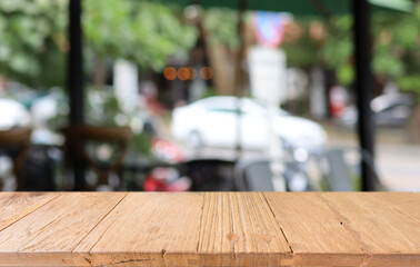 Empty wooden table in front of abstract blurred background of coffee shop . can be used for display or montage your products.Mock up for display of product