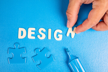 Design. Text from white wooden letters on a blue background