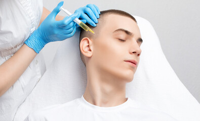 Cosmetologist does prp therapy of a handsome guy in beauty salon. Cosmetology concept.