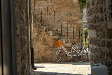 old fashioned bicycle next to stone stairs on narrow streets of old town