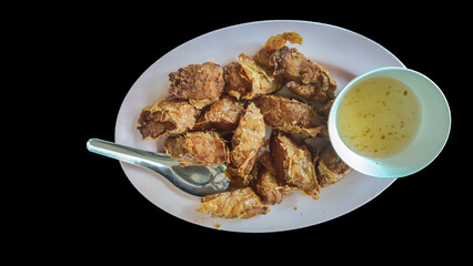 Isolated fried shrimp-rolled with plum Sauce. Black background.
