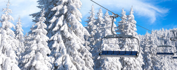 Ski resort, ski lift and snow pine trees