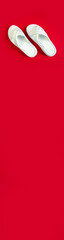 Women's summer white slippers on a red background. Slippers. Vertical banner for insertion into site. Place for text cope space.