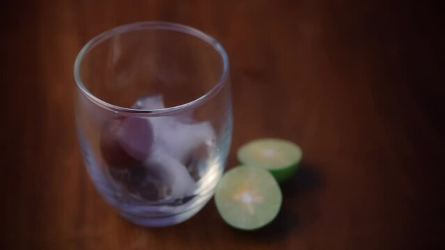 preparation of lemonade with   fresh organic fruit jamun (Syzygium Cumini)  with lime and chilled water and ice ( jamun seeds are kind of Ayurvedic herb for diabetes)
