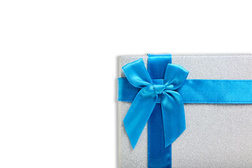 Gift box white background is tied with blue ribbon with bow.