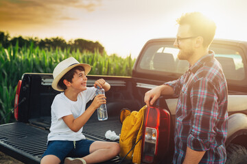father and son outdoor in field talking