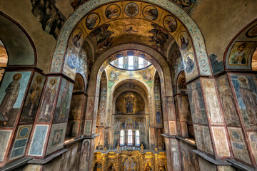 Fototapeta na wymiar Interior of the St. Sophia Cathedral with mosaic Orans of Kyiv, frescoes on the wall and the golden altar. Kyiv, Ukraine