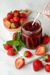 strawberry jam in glass jar and fresh strawberries