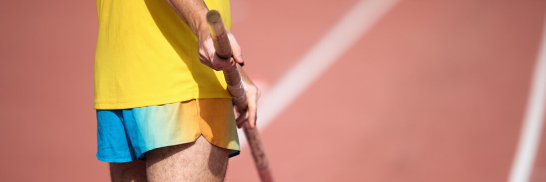Pole vaulter prepares for jump, looking from behind