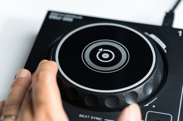 Hamd moving the DJ jocking wheel on a Digital DJ Digital controler.
