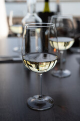 Drinking white dry wine in outdoor cafe with sea view