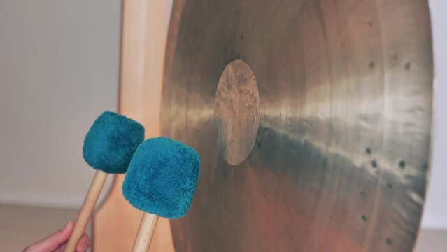 Playing gong during a yoga course