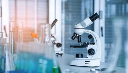 Laboratory research, microscope with lab glassware, science laboratory research and development concept.