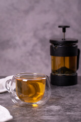 Green tea. Green tea brewed with French press on a dark background. Healthy drinks. Herbal tea concept. close up