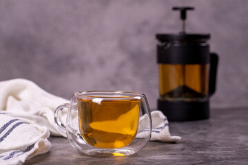 Green tea. Green tea brewed with French press on a dark background. Healthy drinks. Herbal tea concept. close up