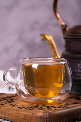 Green tea. Green tea brewed with copper teapot on stone background. Healthy drinks. Herbal tea concept. close up