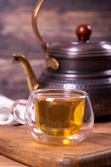 Green tea. Green tea brewed with copper teapot on stone background. Healthy drinks. Herbal tea concept. close up