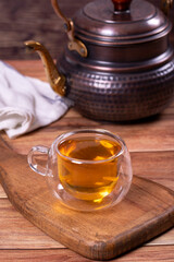 Green tea. Green tea brewed with copper teapot on stone background. Healthy drinks. Herbal tea concept. close up