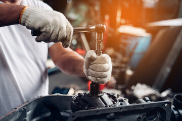 Closeup of auto mechanic are using the wrench to repair and maintenance auto engine is problems at car repair shop.