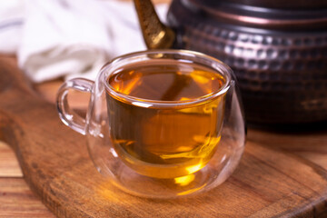 Green tea. Green tea brewed with copper teapot on stone background. Healthy drinks. Herbal tea concept. close up