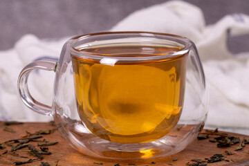 Green tea. Green tea in a wooden serving dish on a stone background. Healthy drinks. Herbal tea concept. close up