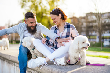 Adult couple enjoying sunny day with their dogs.