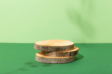 Minimal modern product display on green background. Wood slice podium. Concept scene stage showcase for new product, promotion sale, banner, presentation, cosmetic