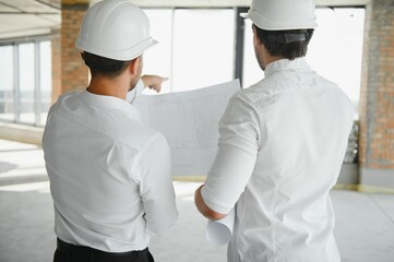 Two young man architect on a building construction site
