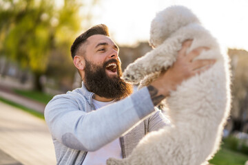 Adult man is enjoying sunny day with his dog.