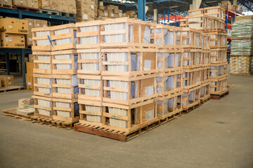 stack of materials in large warehouse with the boxes wrapped with wooden crate on wooden pallet ready to ship to customer