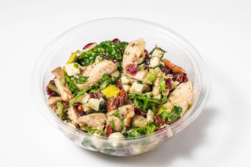 Plastic package with healthy chicken and pear salad for take away or food delivery on white background