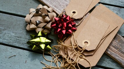 Christmas background with gift bag and tags on distressed wood background