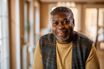 Happy African American senior at nursing home looking at camera. - Powered by Adobe