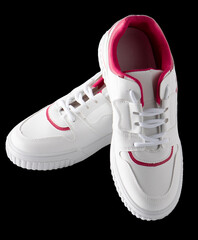 New white sneakers isolated on black background. Fashionable sports shoes. Clean stylish shoe.