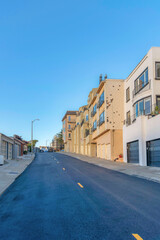 Asphalt road with yellow broken lines in a residential area at San Francisco, California