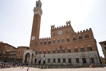 Fototapeta na wymiar Palazzo Pubblico palace and its Torre del Mangia tower in the historic center of Siena, Tuscany, Italy