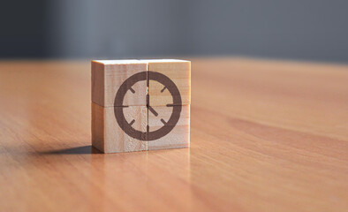 Clock timer symbol on wood blocks on a table to represent hours, minutes, seconds, days, month, year, meeting, date