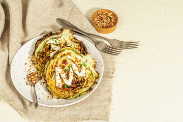 Homemade vegan cabbage steaks with herbs, spices, and sauce. Healthy food ready to eat
