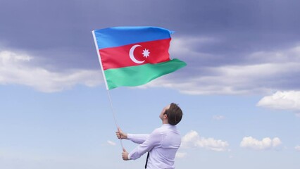 Young man waving the Azerbaijan flag. The Azerbaijan flag is waving in the wind. Patriotism, Country, Victory, Celebration, victory day, liberation, independence day. nature background.