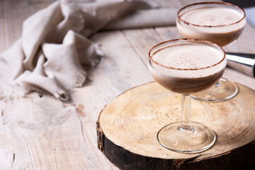 Classic Brandy Alexander cocktail on wooden table. Copy space