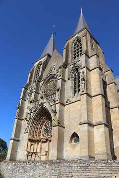 Exterior view of the beautiful gothic style Basilica of Notre Dame of Avioth. Located in the region of Grand Est France, summer view with clear sky.