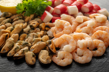 Seafood charcuterie plate board with shrimps, dark background, top view