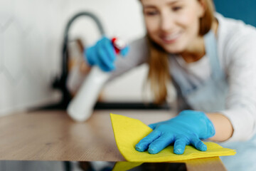 Lady wiping surface with napkin and detergent
