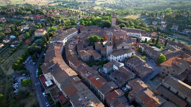 Tuscany Lucignano aerial view of medieval village with elliptical shape at sunset Italy drone footage 4k cinematic hill town isolation in Valdichiana near Siena and Arezzo travel destination