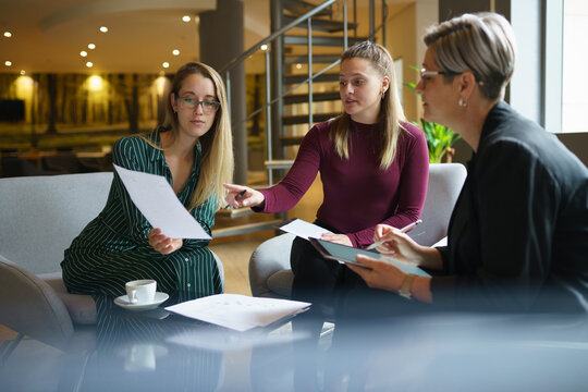 Colleagues showing reports to female manager in meeting