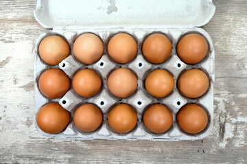 Brown and white chicken eggs in cardboard egg tray. Organic egg for healthy protein breakfast. Easter symbol. Raw chicken eggs. 