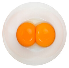Two raw chicken eggs cracked into a bowl. Yolk and white without eggshells. Common food and versatile ingredient in cooking. Isolated macro food photo close up from above on white background.