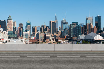 Empty urban asphalt road exterior with city buildings background. New modern highway concrete construction. Concept of way to success. Transportation logistic industry fast delivery. New York. USA.