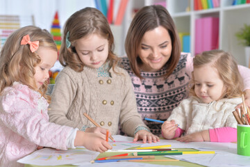 Fototapeta premium Mother and girls drawing